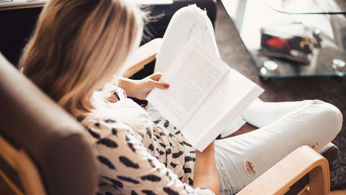 cropped-woman-reading-a-book-in-a-chair-2210x1473.jpg